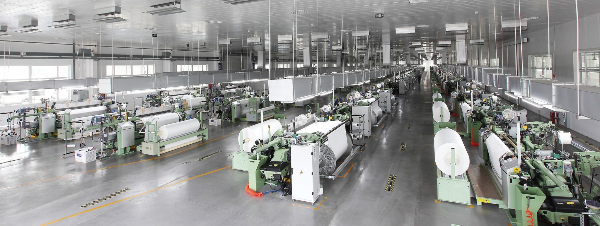 Filter fabric weaving looms inside the Aurora Filtech weaving workshop